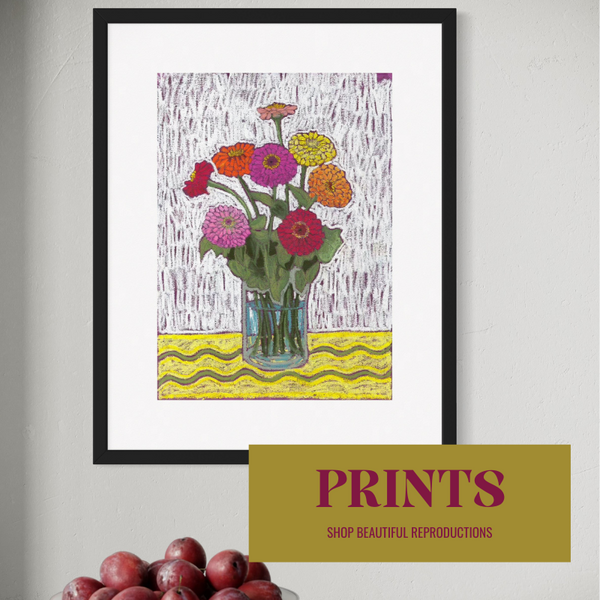 Colorful print of vibrant zinnia flowers in a glass vase, with a yellow wavy tablecloth, framed and displayed in a modern home setting.
